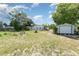 Large backyard with mature trees, detached garage, and cleared areas at 6957 Plymouth Sorrento Rd, Apopka, FL 32712