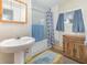 Bathroom features a pedestal sink, shower, and cabinet storage at 6957 Plymouth Sorrento Rd, Apopka, FL 32712