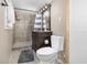 Cozy bathroom features tiled shower, dark wood vanity with vessel sink, and tiled floors at 6957 Plymouth Sorrento Rd, Apopka, FL 32712