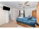 Comfortable bedroom with a ceiling fan and adjacent bathroom with a shower at 6957 Plymouth Sorrento Rd, Apopka, FL 32712