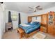 This bedroom features a bed, a ceiling fan, a window, and built in cabinets at 6957 Plymouth Sorrento Rd, Apopka, FL 32712