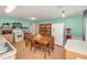 Large eat-in kitchen offering both cabinet and shelving space with a table and standard appliances at 6957 Plymouth Sorrento Rd, Apopka, FL 32712
