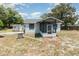 Charming single-story home with a screened front porch, complemented by a small storage shed and landscaped yard at 6957 Plymouth Sorrento Rd, Apopka, FL 32712