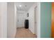Clean hallway with neutral tile flooring, leading to various rooms in the house at 6957 Plymouth Sorrento Rd, Apopka, FL 32712