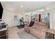 Comfortable living room featuring a plush loveseat, modern decor, and plenty of natural light at 6957 Plymouth Sorrento Rd, Apopka, FL 32712