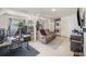 Cozy living room featuring tile flooring, a comfortable reclining sofa, and washer and dryer for added convenience at 6957 Plymouth Sorrento Rd, Apopka, FL 32712
