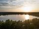 Stunning aerial view of the lake, framed by trees, at sunset at 7 Ne Ivanhoe Blvd, Orlando, FL 32804