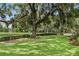 Spacious backyard with mature trees, providing ample shade and a serene atmosphere at 7 Ne Ivanhoe Blvd, Orlando, FL 32804