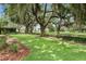 Backyard view featuring beautiful lawn, mature trees, and manicured landscaping at 7 Ne Ivanhoe Blvd, Orlando, FL 32804