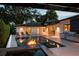 Outdoor living space features a pool, fire pit, outdoor kitchen, and lounge area at 7 Ne Ivanhoe Blvd, Orlando, FL 32804