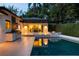 Beautiful outdoor living space features a pool, fire pit, and outdoor kitchen at 7 Ne Ivanhoe Blvd, Orlando, FL 32804