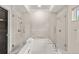 Bathroom featuring soaking tub with dual shower heads and marble accents at 7 Ne Ivanhoe Blvd, Orlando, FL 32804