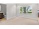 Neutral bedroom featuring carpet, a window with shutters, and open to the bath at 7 Ne Ivanhoe Blvd, Orlando, FL 32804