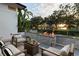 Inviting patio with a stylish fire pit, comfortable seating, and serene lake backdrop at 7 Ne Ivanhoe Blvd, Orlando, FL 32804