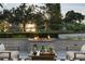 Relaxing outdoor area with a modern fire pit, comfortable seating, and scenic lake views at sunset at 7 Ne Ivanhoe Blvd, Orlando, FL 32804