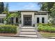 Contemporary home featuring a stylish walkway and modern front door framed by lush landscaping at 7 Ne Ivanhoe Blvd, Orlando, FL 32804