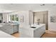 A modern kitchen features a large island with a sink and dishwasher, light grey cabinetry, and stainless appliances at 7 Ne Ivanhoe Blvd, Orlando, FL 32804