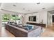Bright living room with large sectional, an entertainment center, recessed lighting and view of backyard pool at 7 Ne Ivanhoe Blvd, Orlando, FL 32804