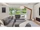 Comfortable living room with a cozy sectional sofa, an accent lamp, and outdoor views at 7 Ne Ivanhoe Blvd, Orlando, FL 32804