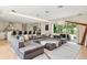 Spacious living room featuring a large sectional sofa, open layout, and access to the backyard at 7 Ne Ivanhoe Blvd, Orlando, FL 32804