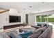 An expansive living room showcasing stylish furnishings, modern media center, and a seamless view of the backyard pool at 7 Ne Ivanhoe Blvd, Orlando, FL 32804