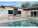 Outdoor kitchen and pool area features a modern grill, sink, and stone accents for easy entertaining at 7 Ne Ivanhoe Blvd, Orlando, FL 32804