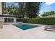 Beautiful backyard with a modern pool, patio, lounging furniture, and lush landscaping for privacy at 7 Ne Ivanhoe Blvd, Orlando, FL 32804