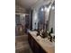 Bathroom featuring double sinks, dark fixtures, and glass shower at 725 Ashworth Overlook Dr # C, Apopka, FL 32712