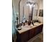 Bathroom featuring double sinks, dark fixtures, and decorative accents at 725 Ashworth Overlook Dr # C, Apopka, FL 32712