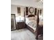 Comfortable bedroom featuring an elegant bed frame and a large mirror at 725 Ashworth Overlook Dr # C, Apopka, FL 32712