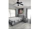 Cozy bedroom with a queen-size bed, ceiling fan, and ample natural light at 725 Ashworth Overlook Dr # C, Apopka, FL 32712