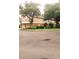 Traditional-style townhome showcasing an attached garage, manicured landscaping, and a corner lot at 725 Ashworth Overlook Dr # C, Apopka, FL 32712