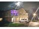 Night view of a two-story home with a truck parked in the driveway and an illuminated, covered balcony at 725 Ashworth Overlook Dr # C, Apopka, FL 32712