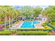 Community pool with chairs and tables provides a refreshing outdoor space for relaxation and socializing at 725 Ashworth Overlook Dr # C, Apopka, FL 32712