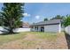 Large backyard with mature tree and white fencing at 7646 Coconut Creek Ct, Orlando, FL 32822