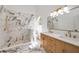 A stunning bathroom featuring double sink, modern fixtures, and luxurious tiled walk-in shower at 7646 Coconut Creek Ct, Orlando, FL 32822