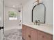 Stylish bathroom featuring a pink vanity, black hardware, and patterned floors at 7646 Coconut Creek Ct, Orlando, FL 32822