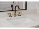 Modern bathroom sink with gold faucet and white countertop at 7646 Coconut Creek Ct, Orlando, FL 32822