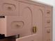 Charming pink bathroom vanity with gold hardware and arched door fronts at 7646 Coconut Creek Ct, Orlando, FL 32822
