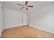 Bright bedroom with ceiling fan and wood-look floors at 7646 Coconut Creek Ct, Orlando, FL 32822