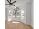 Light and bright bedroom with large arched window, ceiling fan, and wood-look floors at 7646 Coconut Creek Ct, Orlando, FL 32822