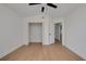 Bright bedroom with light wood floors, closet, ceiling fan, and white trim and walls at 7646 Coconut Creek Ct, Orlando, FL 32822