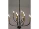 Contemporary chandelier with black and gold candle-style lights hanging from the ceiling at 7646 Coconut Creek Ct, Orlando, FL 32822