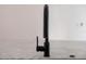 Modern, matte-black faucet on a kitchen island at 7646 Coconut Creek Ct, Orlando, FL 32822