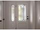 Elegant front door featuring decorative glass panels, sidelight, and complementary hardware at 7646 Coconut Creek Ct, Orlando, FL 32822