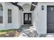 Charming front entry with a black front door and modern lighting at 7646 Coconut Creek Ct, Orlando, FL 32822