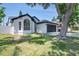 Charming home featuring a well-manicured lawn, an attached garage, and an inviting entrance at 7646 Coconut Creek Ct, Orlando, FL 32822