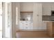 Marble backsplash and white cabinets complement the modern style of the kitchen with stainless steel appliances at 7646 Coconut Creek Ct, Orlando, FL 32822