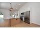 Modern kitchen features stainless steel appliances, an island, and sleek pendant lighting at 7646 Coconut Creek Ct, Orlando, FL 32822