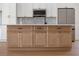 Close-up of kitchen island featuring light wood cabinets, marble countertops, and a black faucet at 7646 Coconut Creek Ct, Orlando, FL 32822